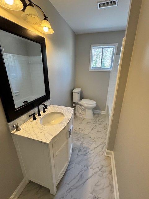 full bath with vanity, visible vents, marble finish floor, and baseboards