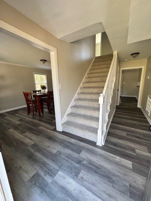 stairway featuring baseboards and wood finished floors