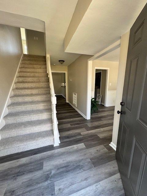 stairway with baseboards and wood finished floors