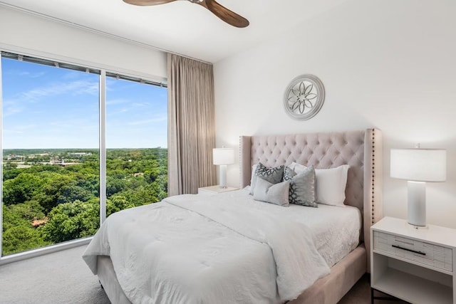 bedroom featuring ceiling fan and carpet