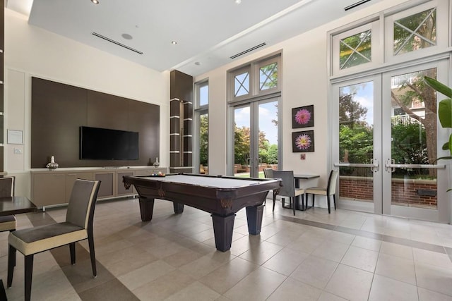 game room featuring pool table, light tile patterned flooring, a towering ceiling, and french doors