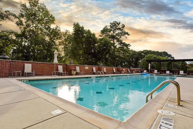 pool at dusk with a patio