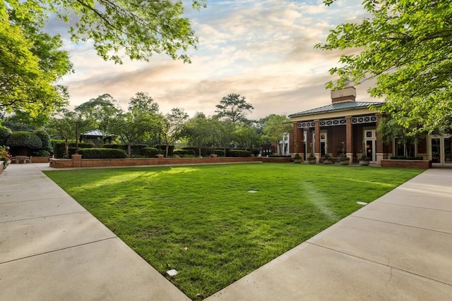 view of property's community with a yard