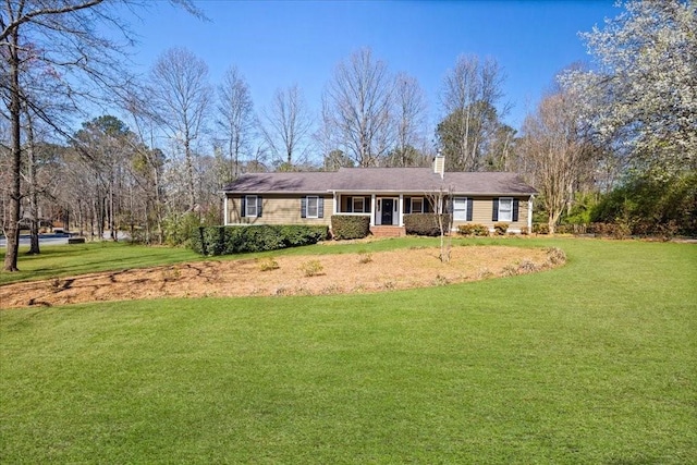 ranch-style home featuring a chimney and a front yard