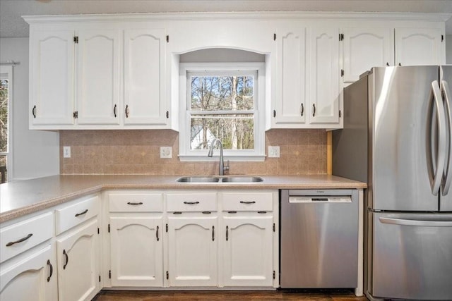 kitchen featuring a sink, light countertops, white cabinets, and stainless steel appliances