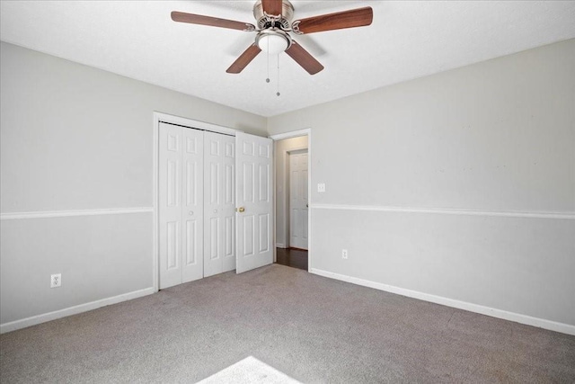 unfurnished bedroom featuring baseboards, carpet floors, a closet, and ceiling fan