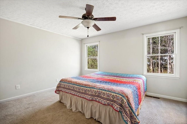 bedroom with baseboards, a textured ceiling, and carpet flooring