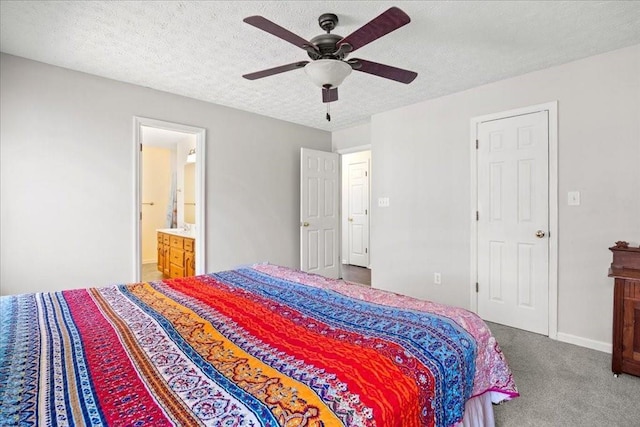 carpeted bedroom featuring baseboards, connected bathroom, a textured ceiling, and ceiling fan