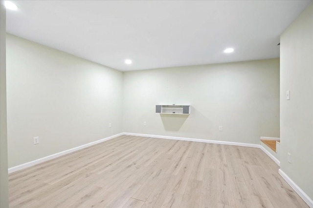 spare room with recessed lighting, baseboards, and light wood-style floors