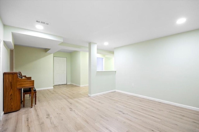 finished below grade area featuring recessed lighting, light wood-style floors, visible vents, and baseboards