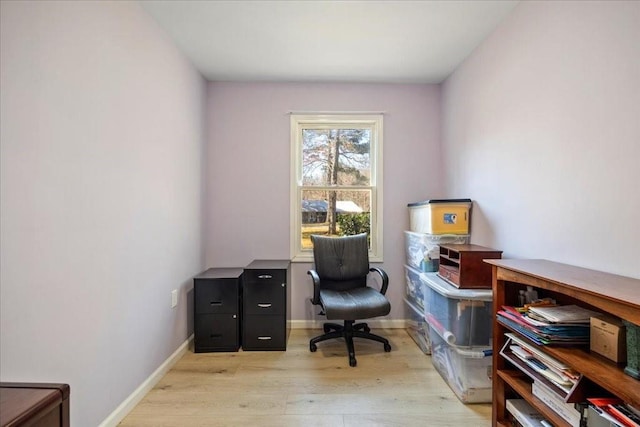 office space with light wood-style flooring and baseboards