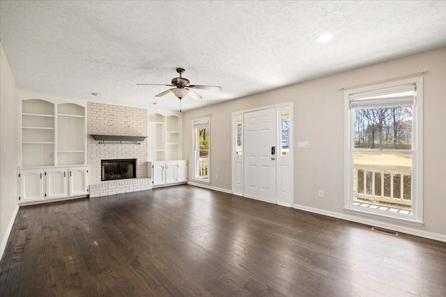 unfurnished living room featuring visible vents, a textured ceiling, and a fireplace