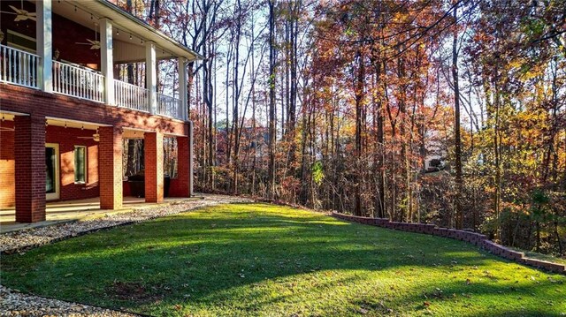 view of yard featuring ceiling fan and a patio area