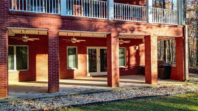 view of exterior entry with a patio and ceiling fan