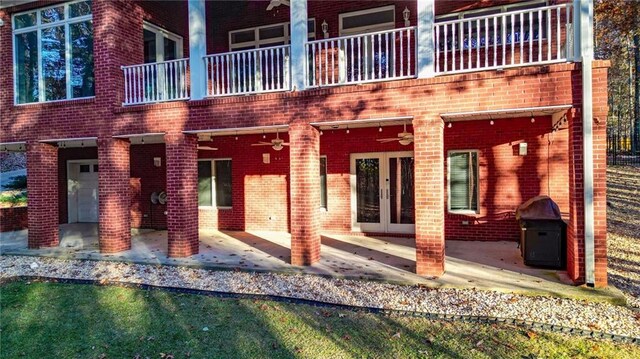 rear view of house featuring french doors, ceiling fan, and a patio area