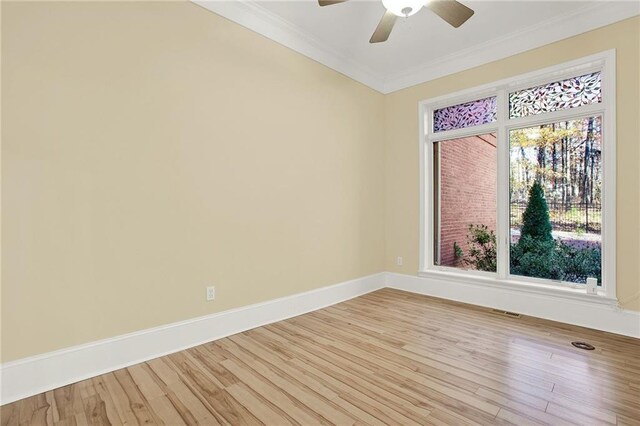 empty room featuring crown molding, ceiling fan, and light wood-type flooring