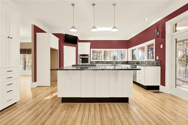 kitchen featuring white cabinets and light hardwood / wood-style floors