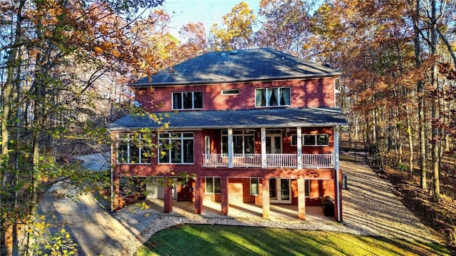 back of house with a lawn, a patio area, and a wooden deck