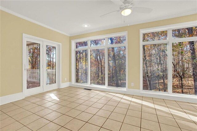 unfurnished sunroom with ceiling fan and a wealth of natural light