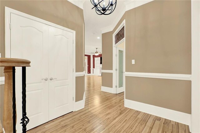 hallway with a chandelier and light wood-type flooring