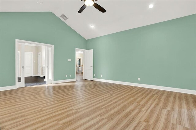 unfurnished bedroom featuring ceiling fan, light wood-type flooring, and high vaulted ceiling