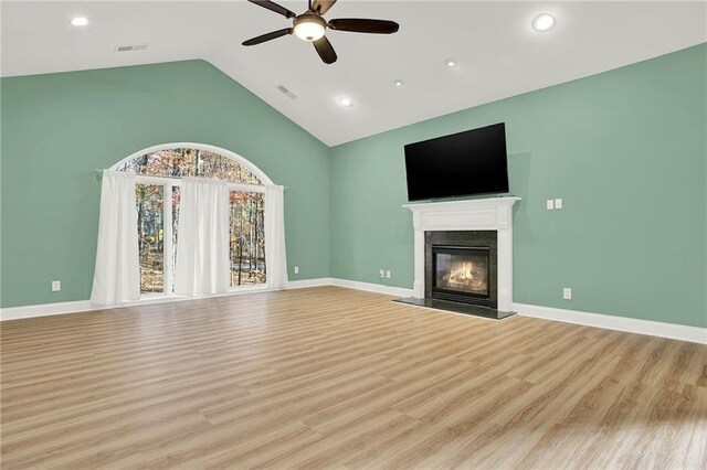 unfurnished living room featuring high vaulted ceiling, light hardwood / wood-style flooring, and ceiling fan