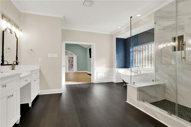 bathroom featuring wood-type flooring, vanity, separate shower and tub, and ornamental molding