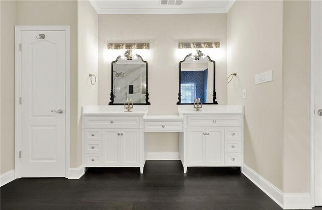 bathroom featuring crown molding, vanity, and hardwood / wood-style flooring