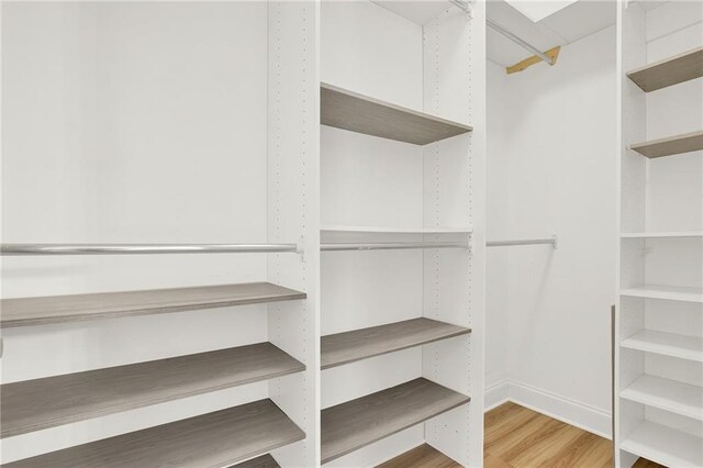 walk in closet featuring hardwood / wood-style flooring