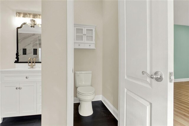 bathroom featuring hardwood / wood-style floors, vanity, and toilet