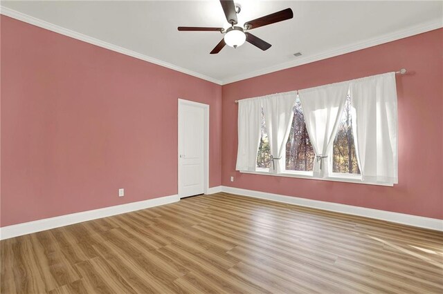 spare room with hardwood / wood-style floors, ceiling fan, and ornamental molding