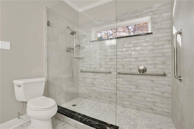 bathroom featuring toilet, ornamental molding, and tiled shower