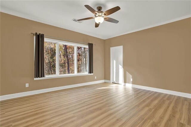 spare room with crown molding, light hardwood / wood-style flooring, and ceiling fan