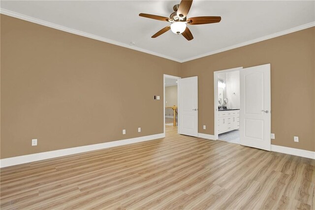 unfurnished bedroom featuring ceiling fan, light hardwood / wood-style floors, crown molding, and connected bathroom