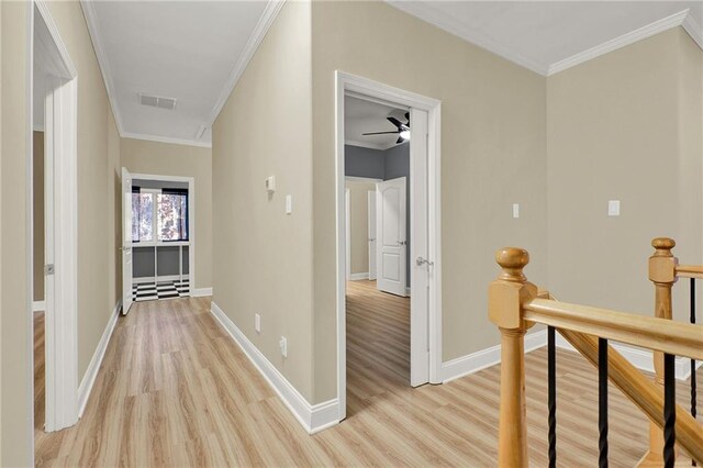 hallway featuring light hardwood / wood-style flooring and crown molding