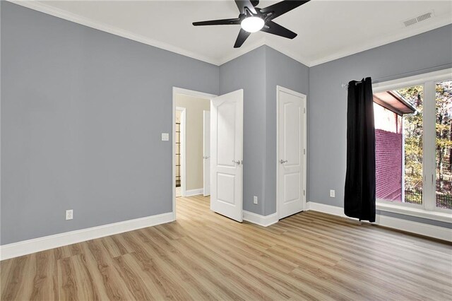 unfurnished bedroom featuring ceiling fan, crown molding, and light wood-type flooring