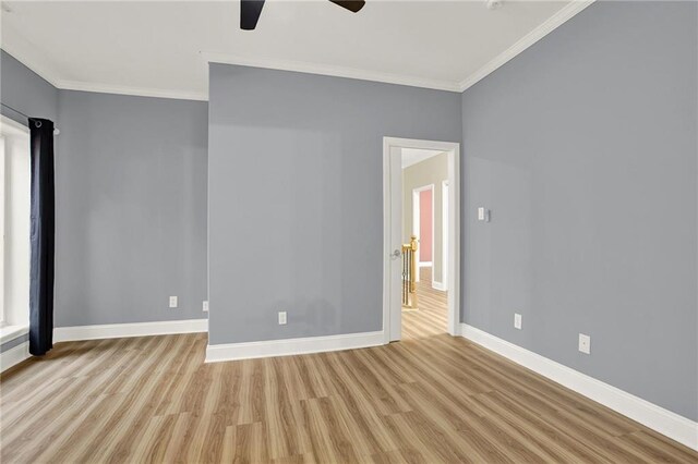 empty room featuring crown molding, ceiling fan, and light wood-type flooring