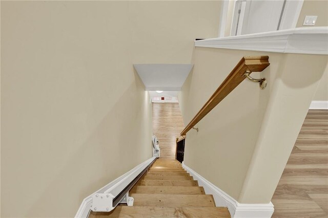 stairway featuring hardwood / wood-style floors