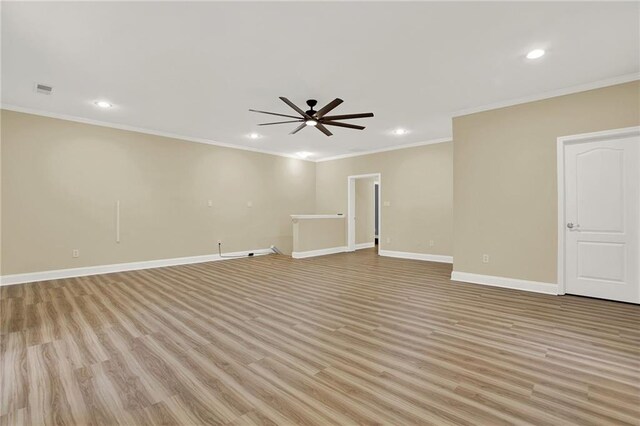 empty room featuring light hardwood / wood-style flooring, ceiling fan, and ornamental molding