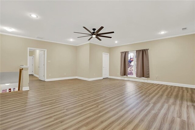 unfurnished room with ceiling fan, light hardwood / wood-style floors, and crown molding