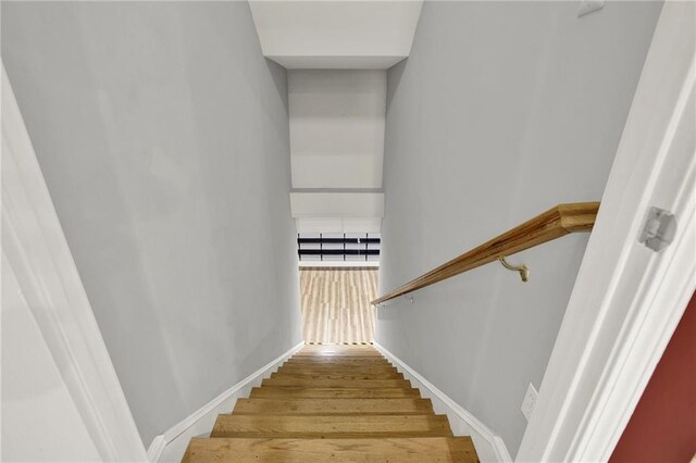 stairs featuring hardwood / wood-style floors