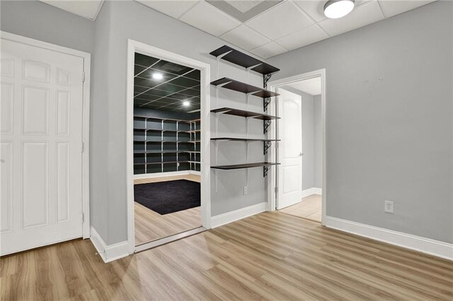 interior space featuring a paneled ceiling and light wood-type flooring