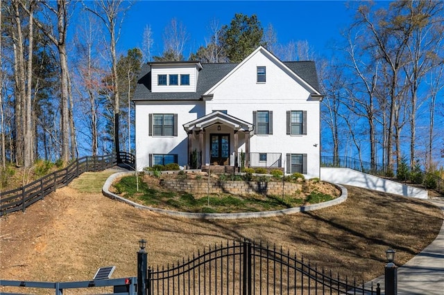 view of front of house featuring a gate, stucco siding, and fence