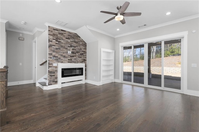 unfurnished living room with visible vents, wood finished floors, a fireplace, and ornamental molding