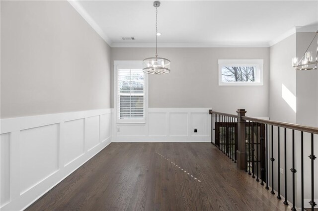 unfurnished dining area with dark wood-style floors, a wealth of natural light, and a chandelier