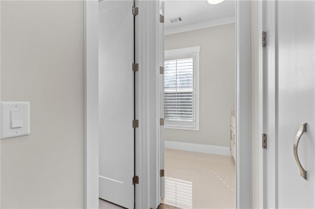 hallway featuring visible vents and crown molding