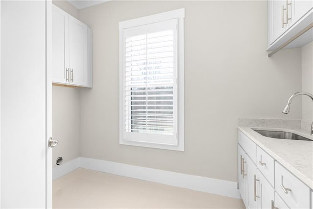 laundry area with a wealth of natural light and a sink