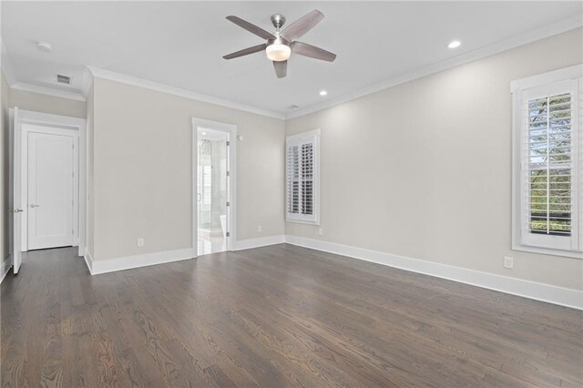 empty room with baseboards, a healthy amount of sunlight, dark wood-style floors, and crown molding