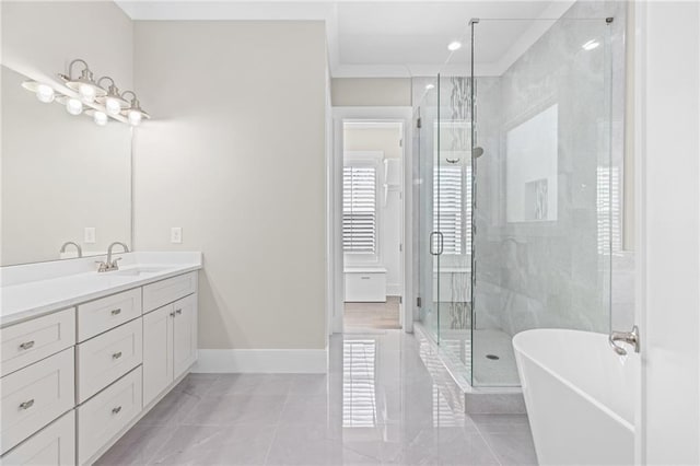 full bath with vanity, baseboards, a stall shower, a freestanding bath, and tile patterned floors