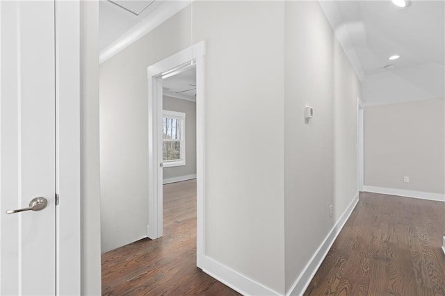 corridor featuring recessed lighting, dark wood-type flooring, and baseboards